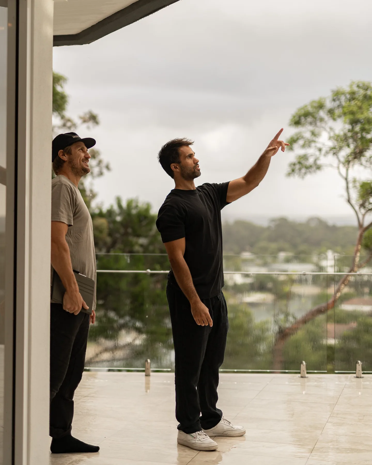 Two people on a balcony looking out over the river