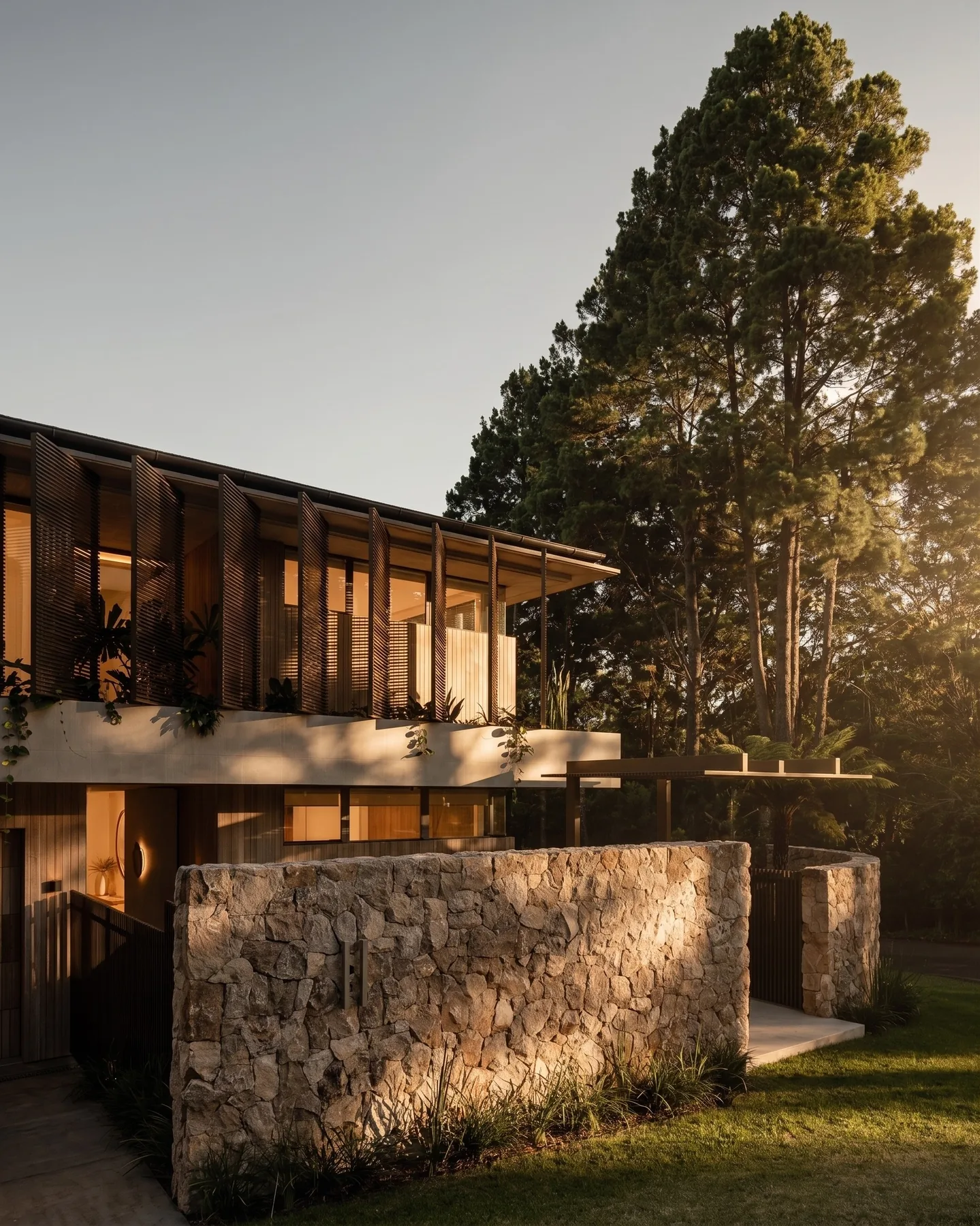 A timber and stone house facade in late afternoon light