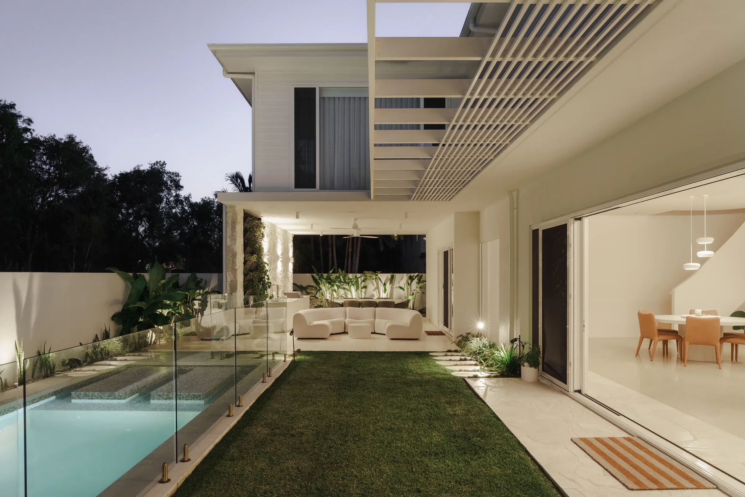 A long lap pool running beside a house