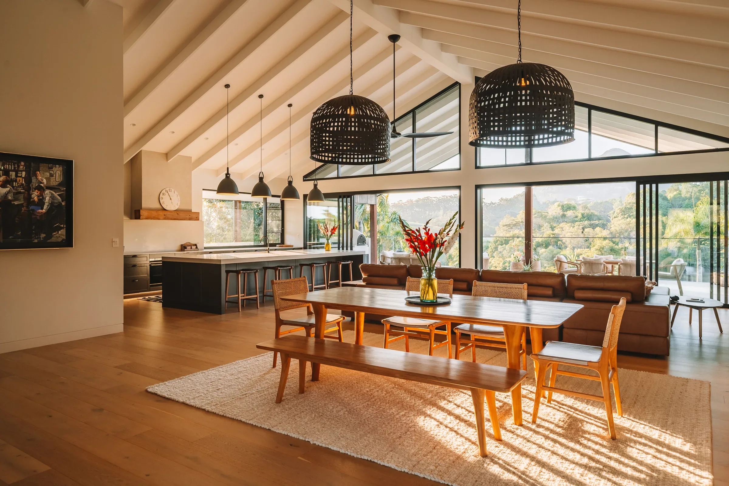 A raked-ceiling living and dining room in afternoon light
