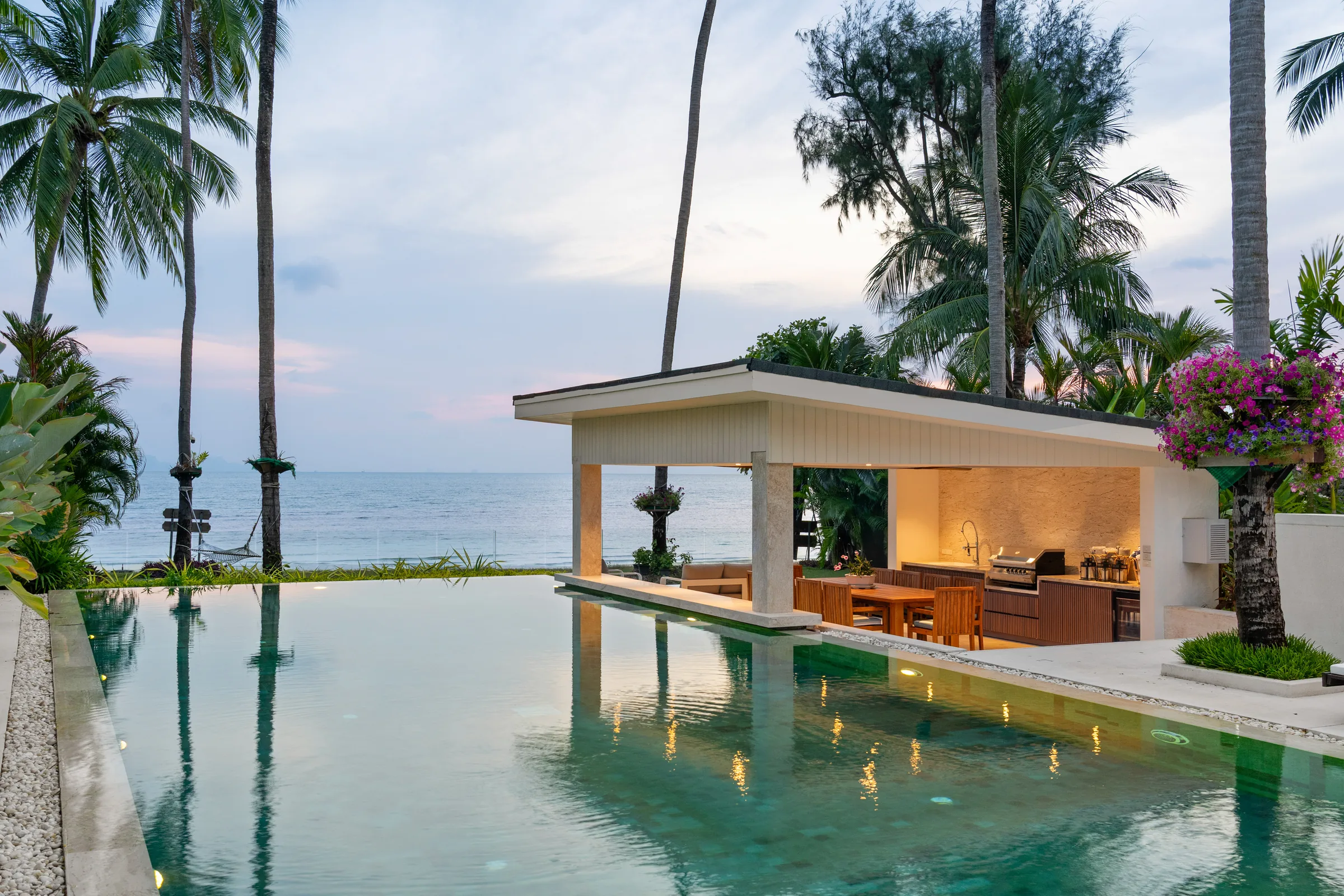 An infinity pool and pavilion looking out to the sea
